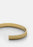 Gold plated ribbed cuff bracelet by Skultuna, featuring textured design and sleek metallic finish, styled as a fashionable accessory.