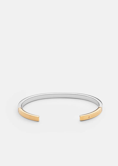 Skultuna SB Cuff Thin two-tone steel and gold accessory with sleek, minimalist design for stylish wear.