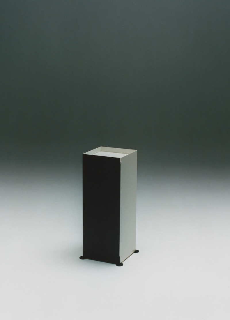 Modern black personal storage table from New Works Unit 003 series, featuring a sleek, minimalist design with a smooth surface.