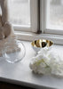 Skultuna Pomme accessories in polished metal with sleek, modern design and rounded shape.