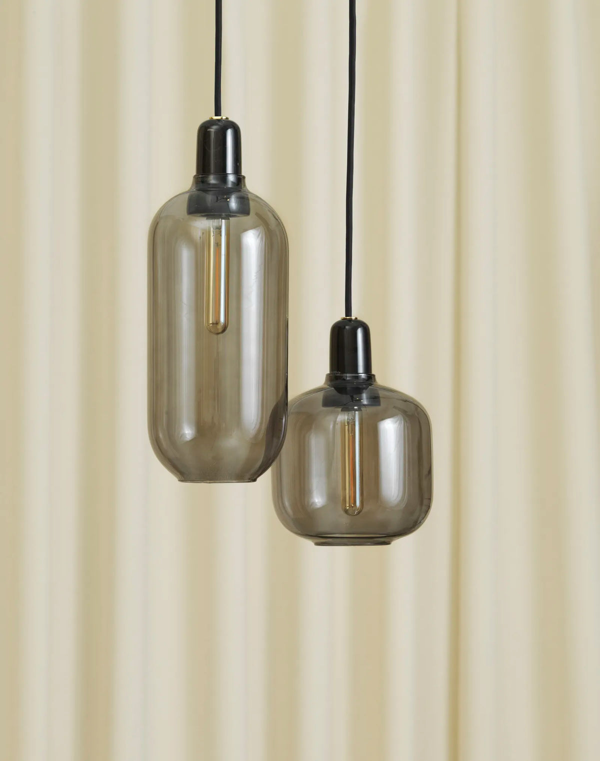 Large Amp Lamp by Normann Copenhagen in smoke black with a sleek, modern lighting design.