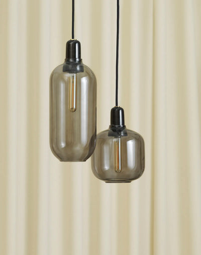 Large Amp Lamp by Normann Copenhagen in smoke black with a sleek, modern lighting design.