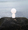 Small white Yo table lamp by Normann Copenhagen, modern lighting fixture with a sleek, minimalist design.