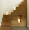 Small white Yo Table Lamp by Normann Copenhagen, modern lighting fixture with sleek design and smooth surface.