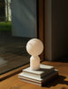 Small white Yo Table Lamp by Normann Copenhagen, modern lighting fixture with a sleek, minimalist design for indoor use.