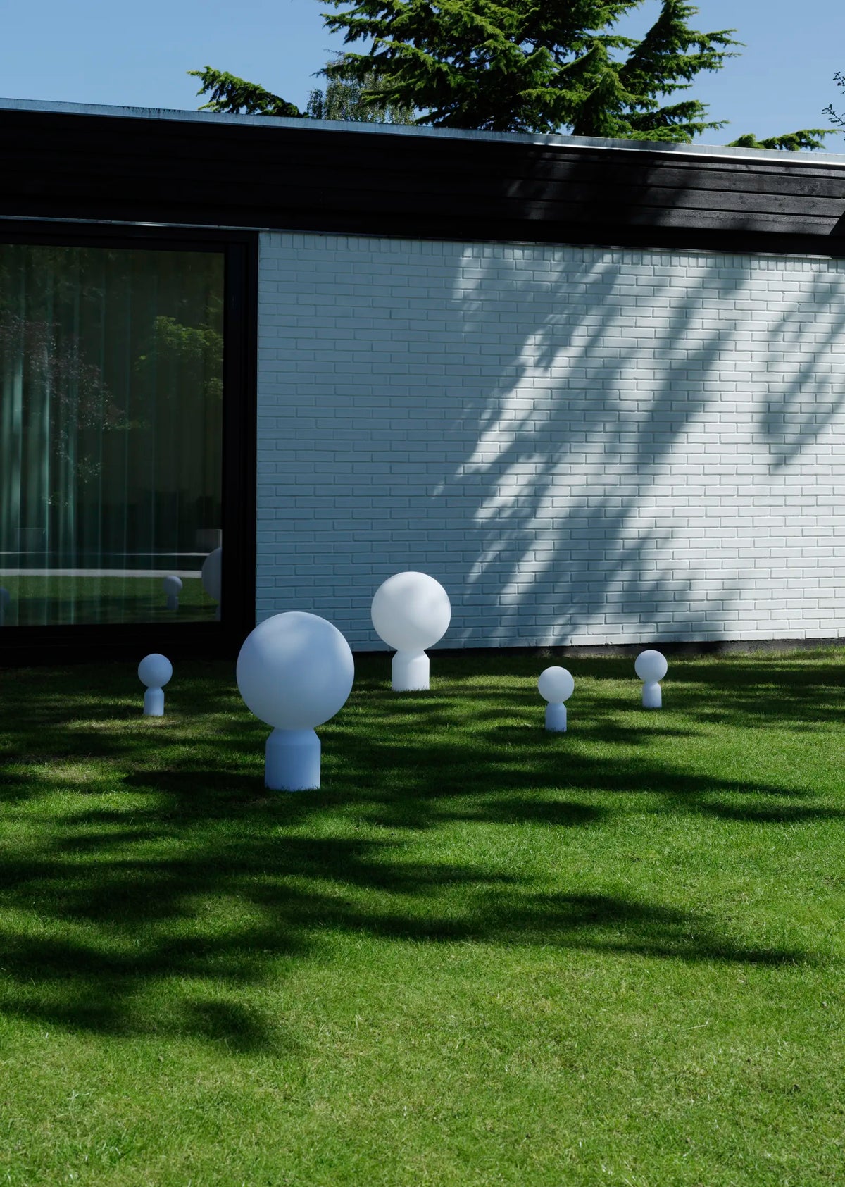 Small Yo Table Lamp by Normann Copenhagen, modern lighting with a sleek design, shown in a well-lit setting.