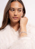 Silver plated Simplicity Pavé bangle by Skultuna, featuring embedded sparkling stones, worn on a wrist.