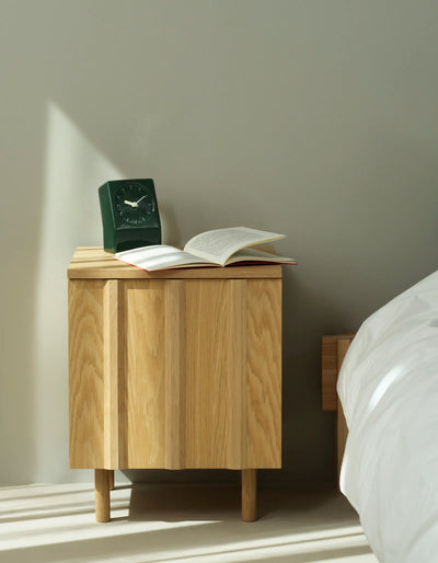 Rib Bedside Table by Normann Copenhagen featuring a sleek oak finish and modern design for bedroom storage and decor.