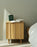 Rib Bedside Table by Normann Copenhagen featuring a sleek oak finish and modern design for bedroom storage and decor.