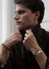 Silver plated ribbed cuff bracelet by Skultuna, featuring textured design and sleek metallic finish, shown on a neutral background.