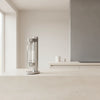 Stelton Brus Carbonator accessory with sleek black design, used for carbonating beverages in a modern kitchen setting.