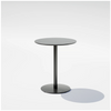 Black round pedestal cafe table by Bend Goods with sleek modern design, perfect for small dining or café settings.