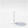 Round pedestal cafe table by Bend Goods with a sleek metal base and smooth surface, ideal for stylish dining or cafe settings.