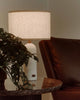 Gubi Gravity Table Lamp in a modern lighting design with a sleek, sculptural form on a showroom display.