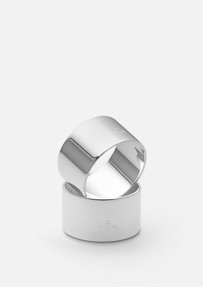 Set of two silver-plated Skultuna napkin rings with elegant design, perfect for sophisticated table settings.