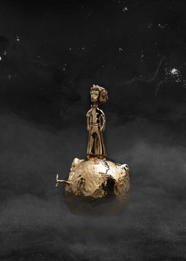 Skultuna Le Petit Prince on his Planet accessories featuring a miniature figurine of the Little Prince on a small planet.