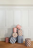 Set of three OYOY Stripe storage boxes in vibrant colors, featuring a modern striped design for organizing accessories.
