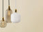Large brass Amp Lamp by Normann Copenhagen, modern lighting fixture with a sleek, minimalist design.