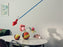 Modern 265 by Flos lighting fixture with sleek design and adjustable arm, mounted on a white wall.