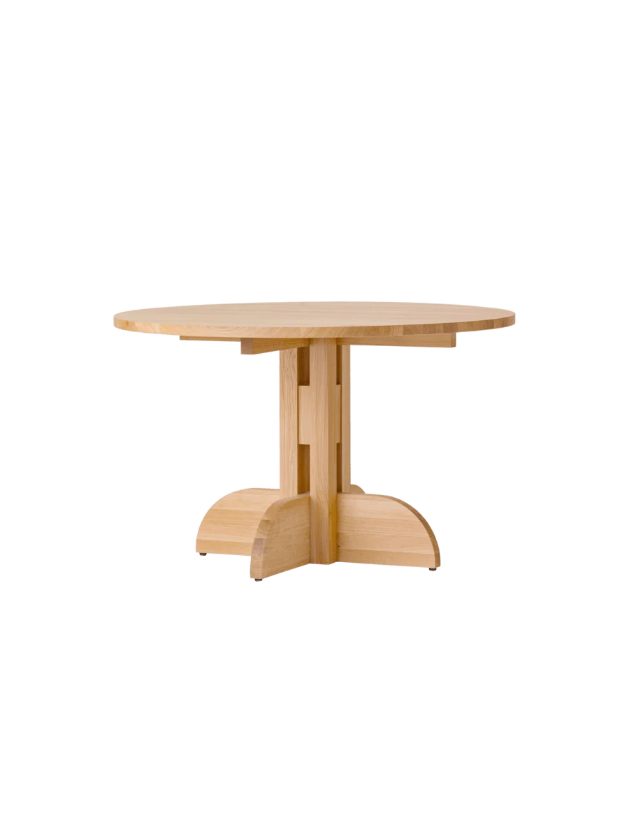 Audo Copenhagen Puffin dining table made of natural oak solid wood, shown from an angled view highlighting its sleek design.