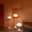 Louis Poulsen Panthella Floor lamp with white, curved, dome-shaped shade and slim stand, modern lighting design.