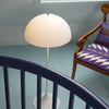 Louis Poulsen Panthella Floor lamp with white curved shade and slender base, modern lighting fixture for living spaces.