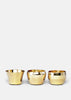 Skultuna Kin accessories displayed on a wooden surface, featuring sleek, modern design and polished metallic finishes.