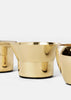 Elegant Skultuna Kin accessories with sleek design, featuring modern shapes and polished metal finishes.