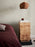 Burl side table by Ferm Living featuring a round top and wooden legs, ideal for modern living room decor.