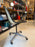 Vintage Charles Eames PSCC Herman Miller rolling task chair with black seat and wooden armrests, modern seating design.