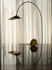Ferm Living Arum arched floor lamp with a sleek metallic finish and a curved arm, ideal for modern living room lighting.