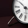 Roman table clock by Arne Jacobsen, featuring a sleek modern design and minimalist accessories style.