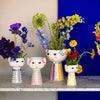 Five Eva vases by Bjørn Wiinblad arranged on a shelf, showcasing colorful, decorative ceramic accessories with intricate patterns.