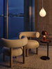 Tom Dixon Bell portable light in high-gloss burgundy finish, showcasing its sleek, modern design and compact size.