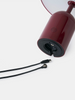 Tom Dixon Bell portable light in high-gloss burgundy finish, showcasing its compact, modern lighting design.