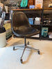 Vintage Charles Eames PSCC Herman Miller rolling task chair with black seating and chrome base, modern office seating design.