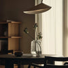 Arum Arched Floor Lamp by Ferm Living featuring a sleek, modern design with a curved metal arm and a minimalist lampshade.