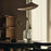 Arum Arched Floor Lamp by Ferm Living featuring a sleek, modern design with a curved metal arm and a minimalist lampshade.