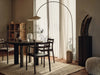 Ferm Living Arum Arched Floor Lamp with sleek black metal arch and minimalist design, ideal for modern living spaces.