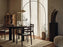 Ferm Living Arum Arched Floor Lamp with sleek black metal arch and minimalist design, ideal for modern living spaces.