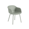 Fiber Outdoor Armchair by Muuto in dusty green, showcasing a stylish, modern outdoor seating design with a comfortable armrest.