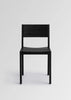 Vaarnii Maasto dining chair with wooden frame and upholstered seat, modern seating furniture on a neutral background.