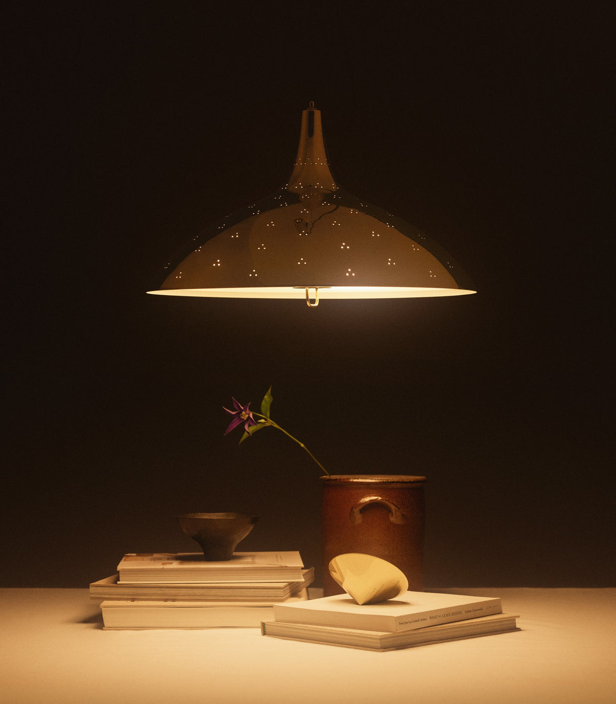 Elegant 1965 Pendant lighting by Gubi hanging from the ceiling, showcasing its sleek, modern design and warm illumination.