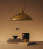 Gubi 1965 pendant light with a sleek, modern design hanging in a stylish interior setting.