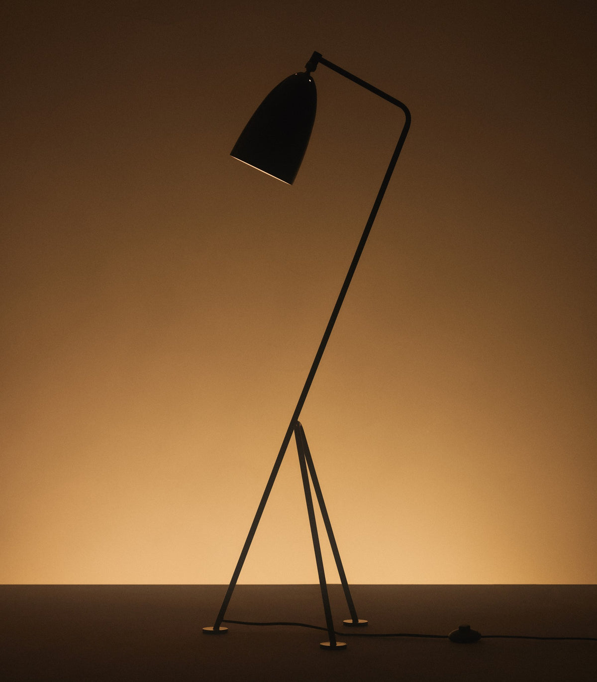 Gubi Gräshoppa floor lamp with a sleek metal stand and adjustable shade, modern lighting design for contemporary interiors.