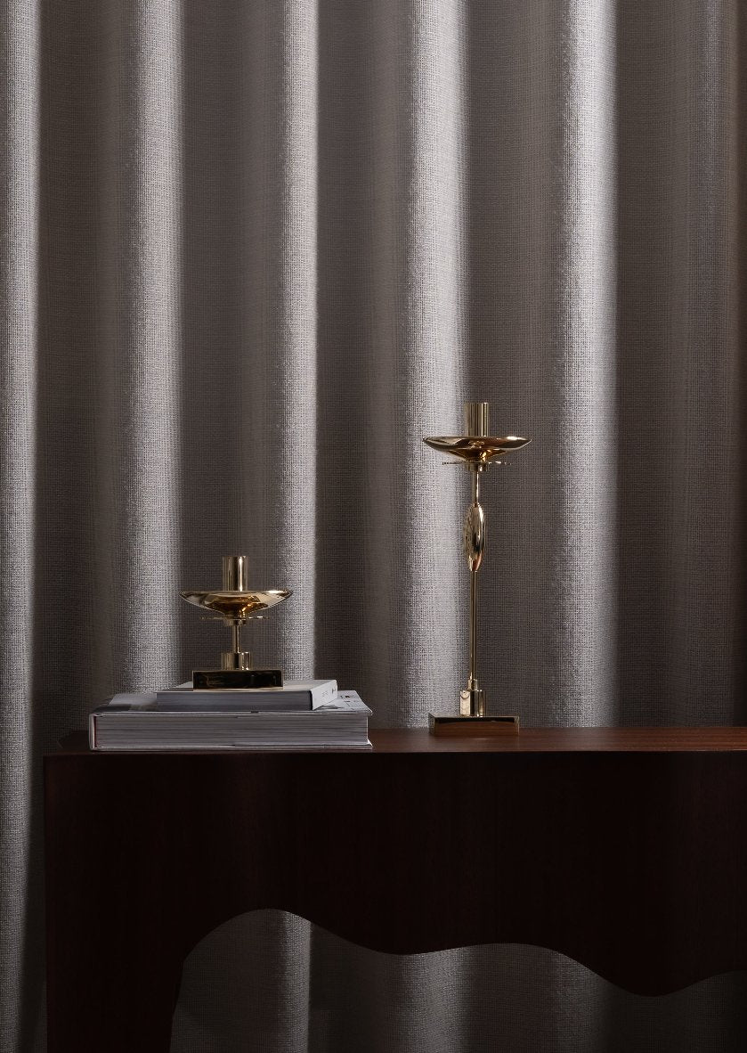 Skultuna Veermakers Carlo accessories displayed on a table with a modern design and elegant metallic finish.