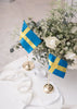 Modern Flagpole accessory by Skultuna featuring a sleek design, displayed on a flagpole with a blue sky background.