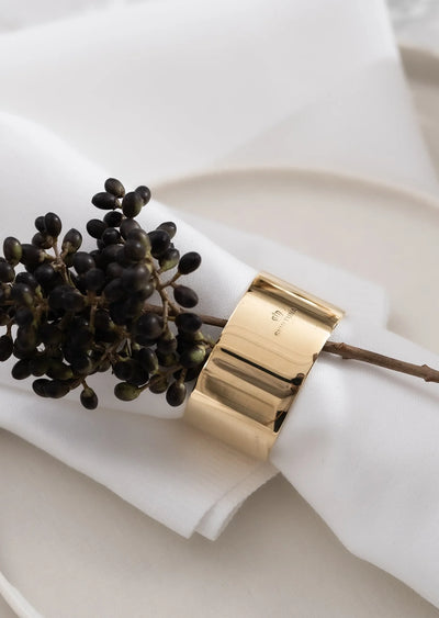 Set of 2 Skultuna napkin rings, elegant accessories with a sleek design, shown on a table setting in the image.