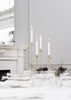 Skultuna Nattlight Candlestick displayed on a surface with a warm, ambient glow, showcasing elegant accessories design.
