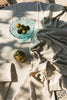Handloom tablecloth by Lorena Canals featuring natural woven fabric, styled as a decorative accessory for dining or living spaces.